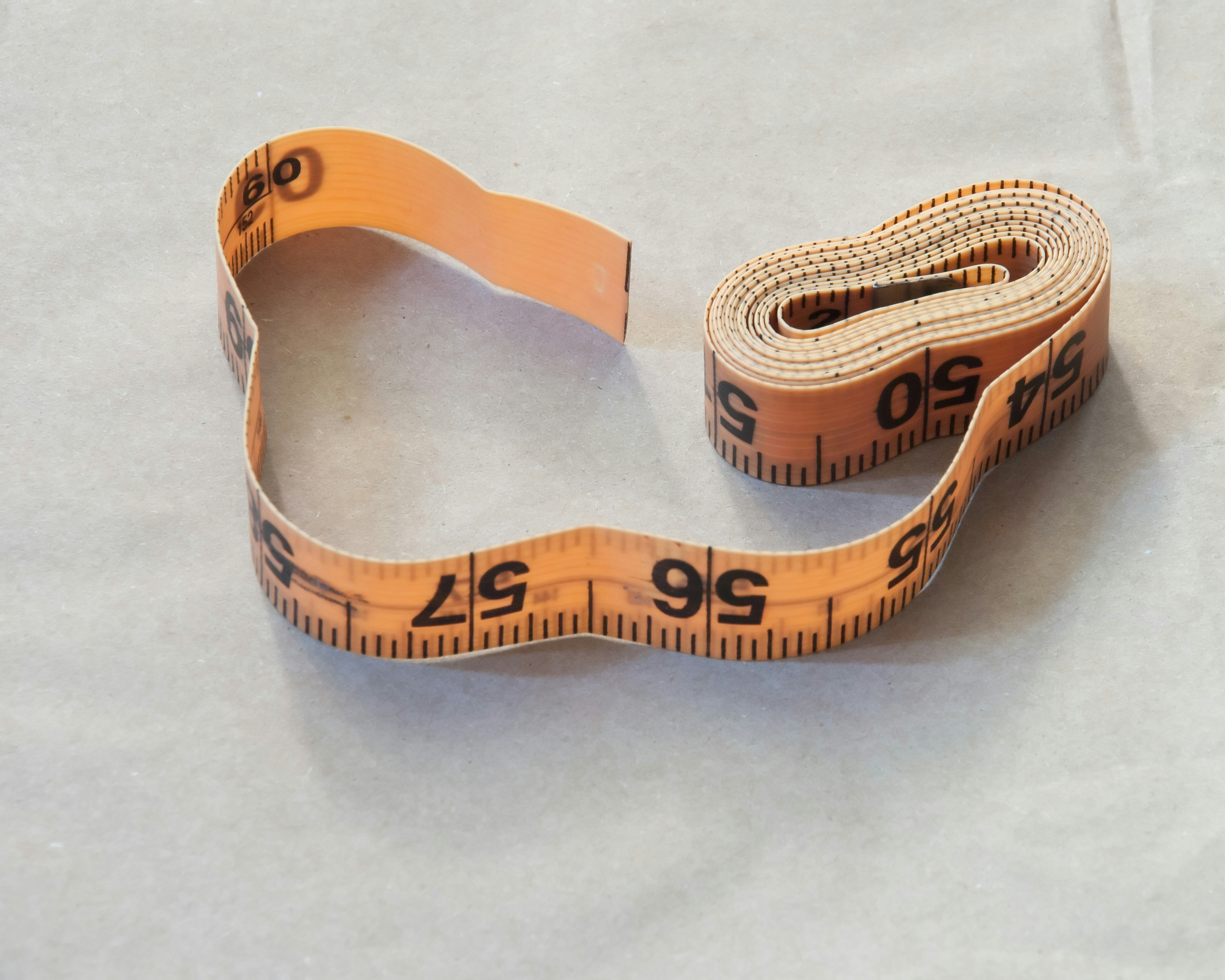 Person measuring waist with tape measure