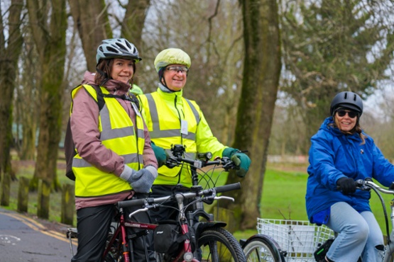 Three people riding bikes