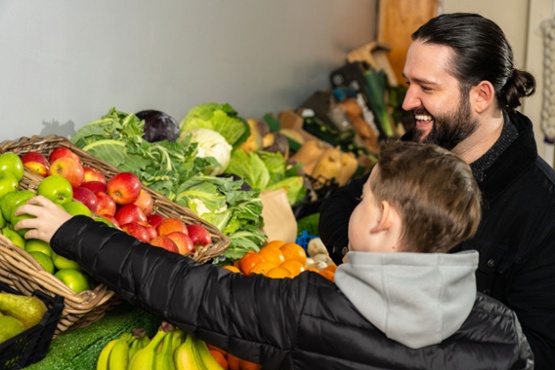 Man and a boy shopping for fruit and vegetables