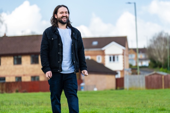 A man smiling in a park