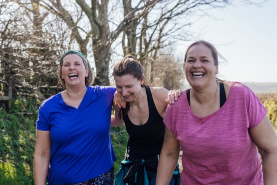 Three ladies walking and laughing