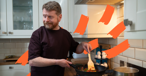 Man cooking a healthy balanced meal after getting back on track after setbacks